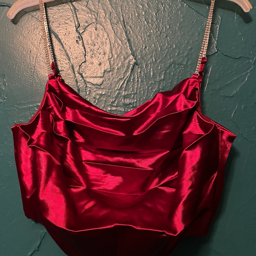 Red shiny corset with rhinestone straps and back zipper.